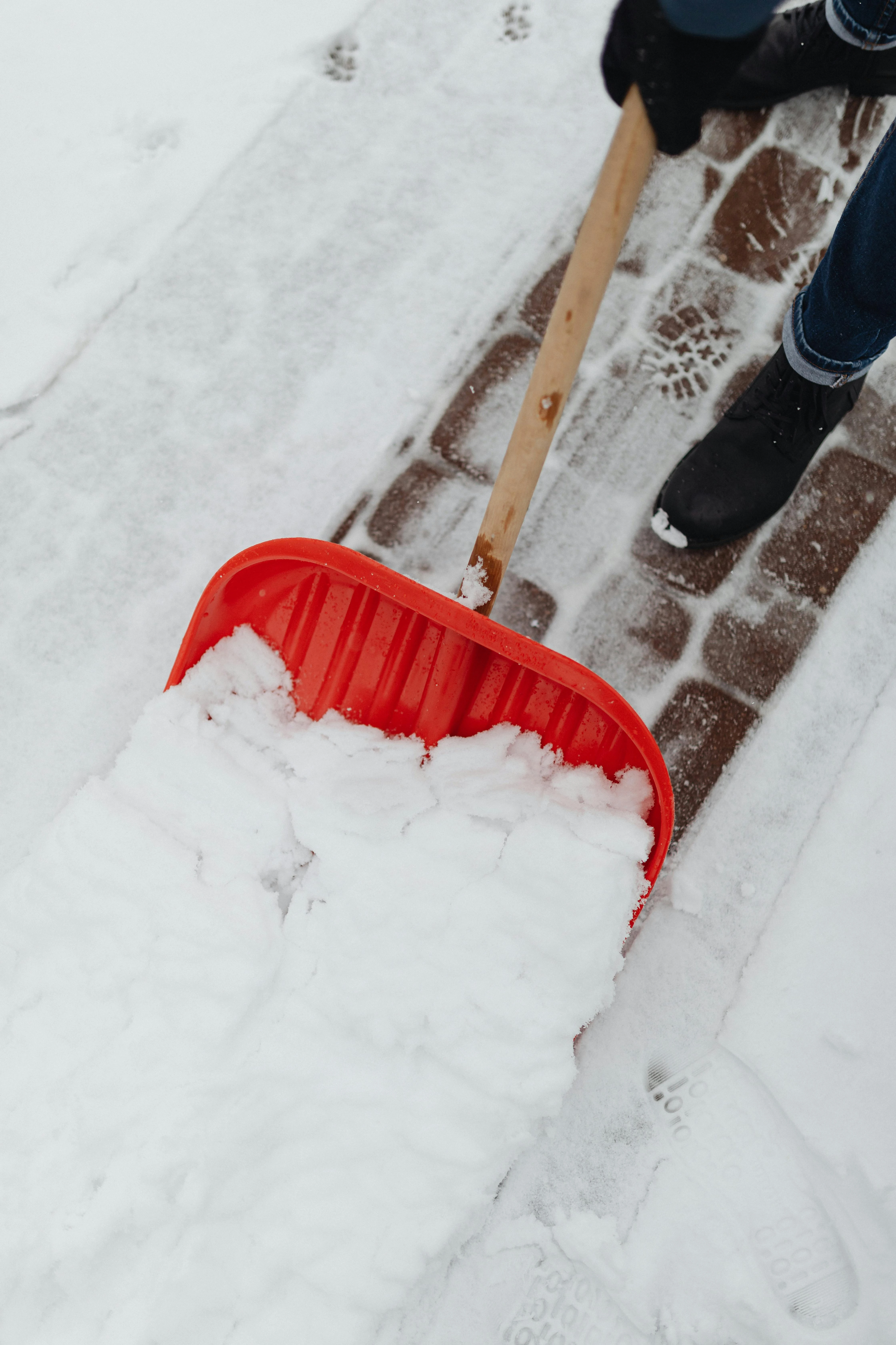 Person shoveling snow from a residential walkway